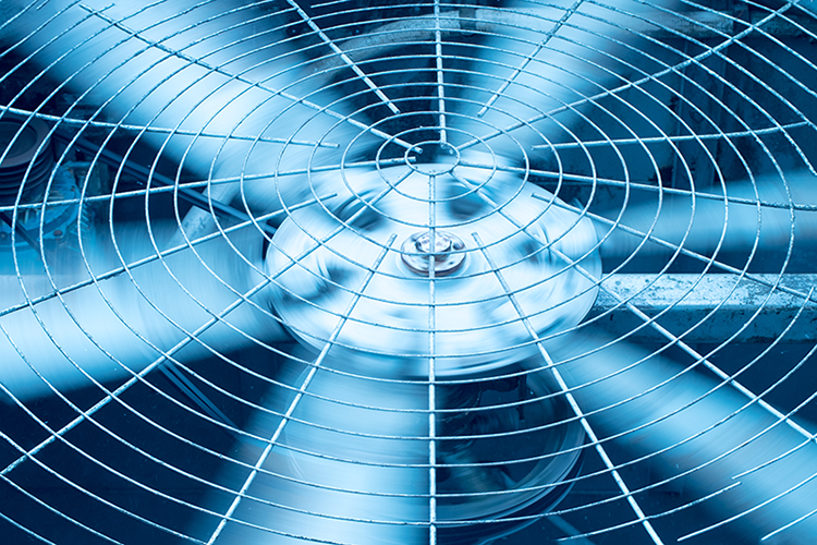 Blog Title: What Is the Difference Between Single-Stage and Variable-Speed ACs? Photo: close up of an AC fan