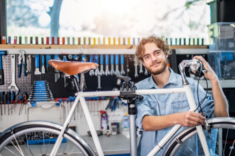 5 Things You Should Know About Geothermal Maintenance. Smiling young man and his bike.